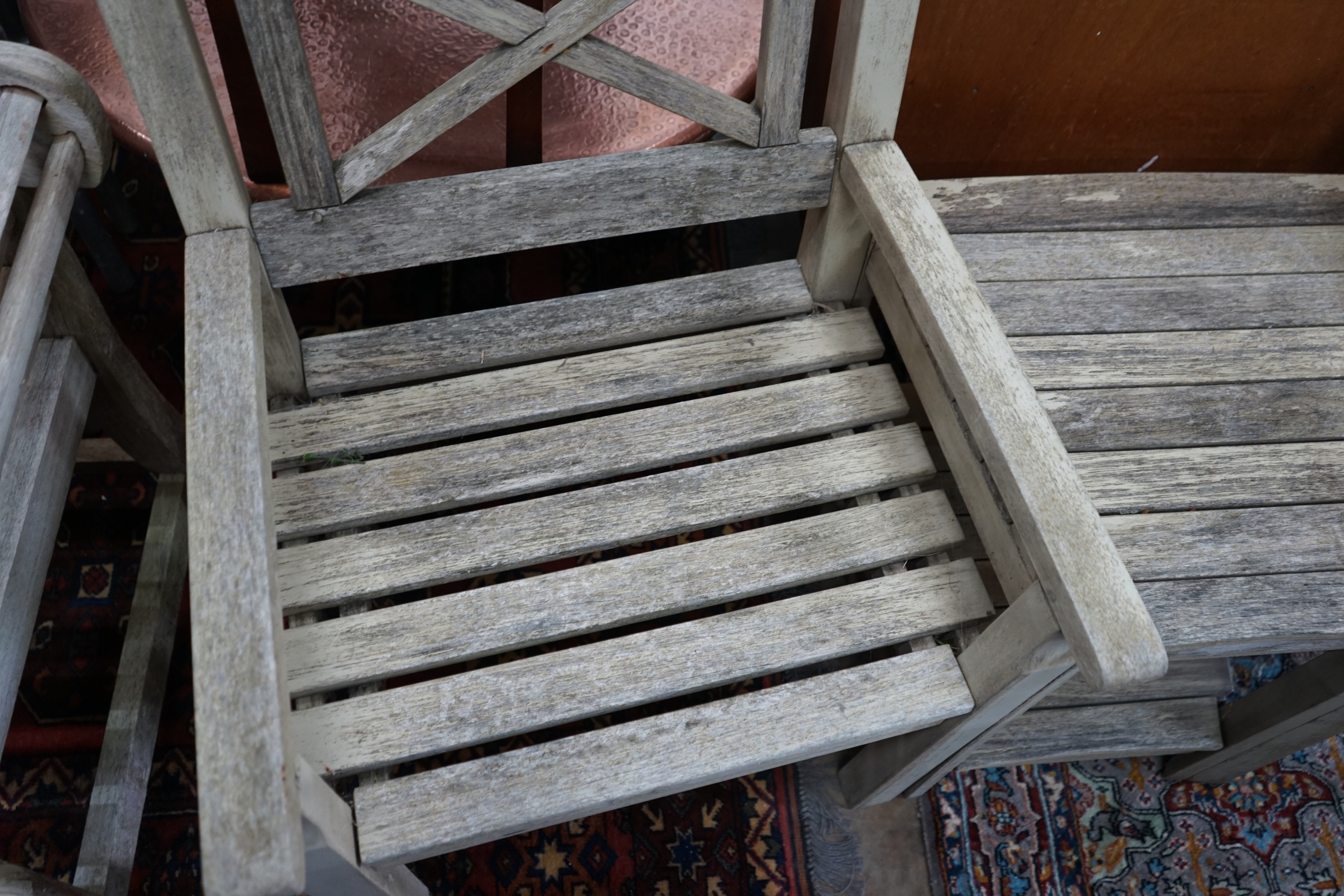 A weathered teak 'duet' garden seat, length 170cm width 52cm height 92cm